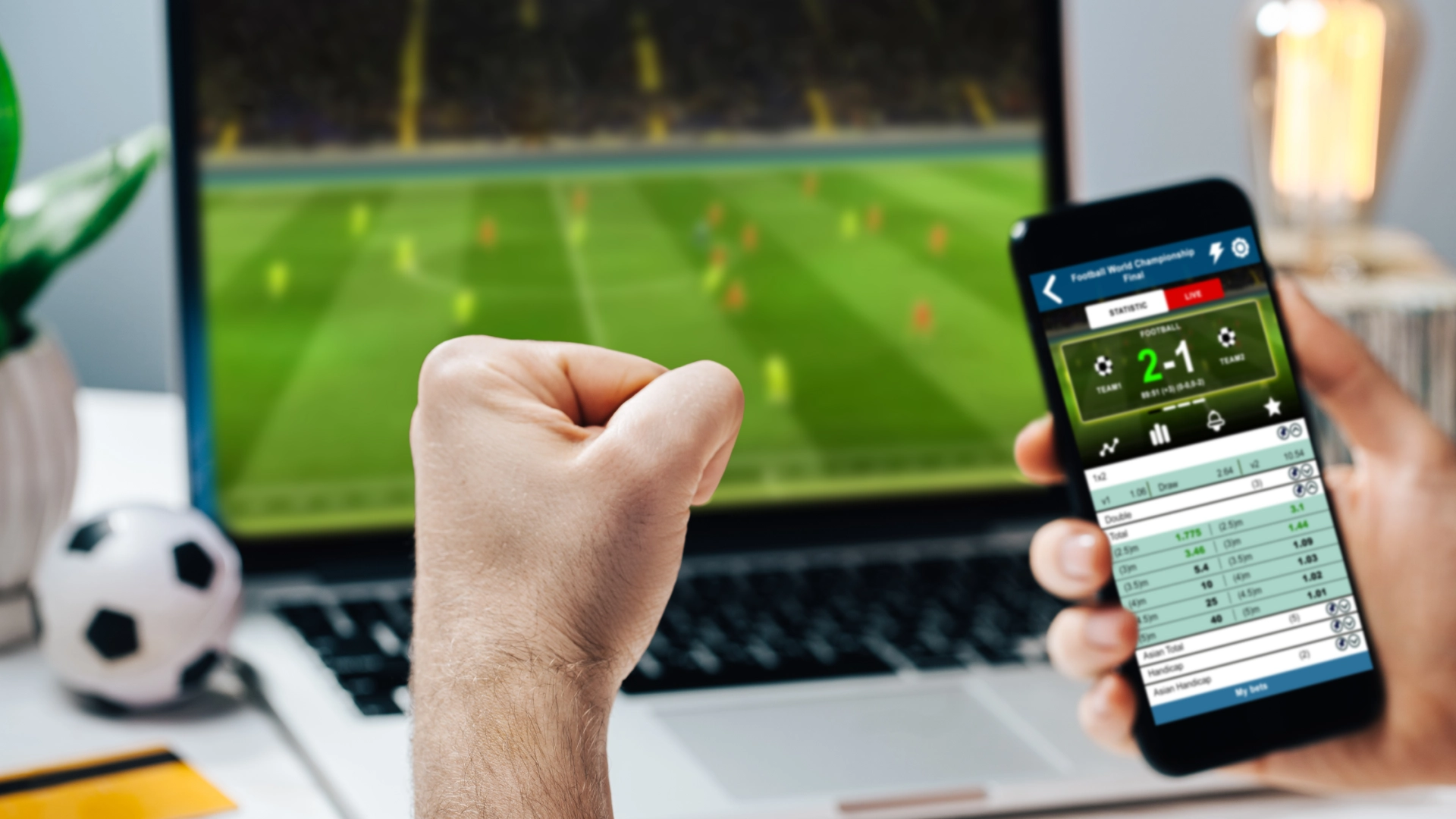 image betting on their phone at a football